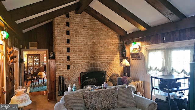 living room with vaulted ceiling with beams, a fireplace, and carpet flooring