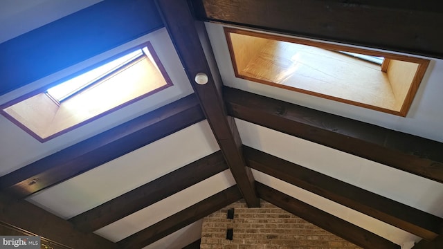 room details featuring beamed ceiling and a skylight