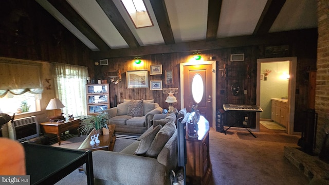 living room with wooden walls, vaulted ceiling with beams, and carpet flooring