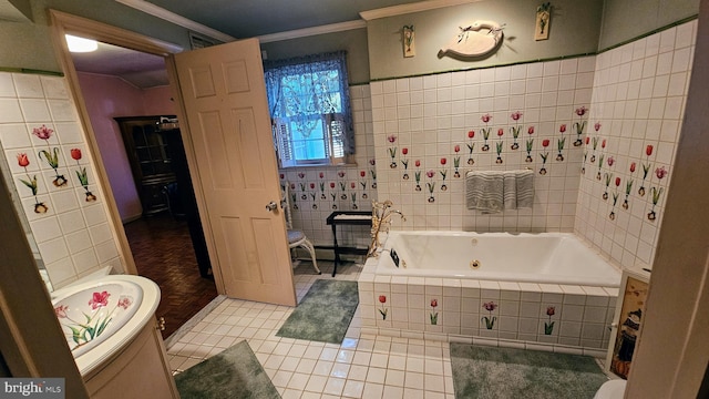 bathroom featuring tile walls, tile patterned floors, ornamental molding, and a relaxing tiled tub