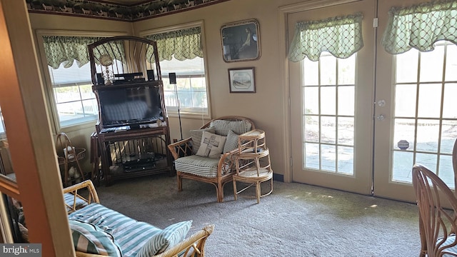 sitting room featuring french doors and carpet flooring