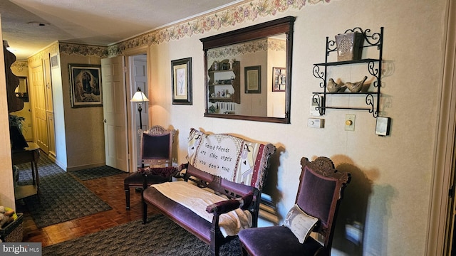 living area with crown molding, a textured ceiling, and dark parquet flooring