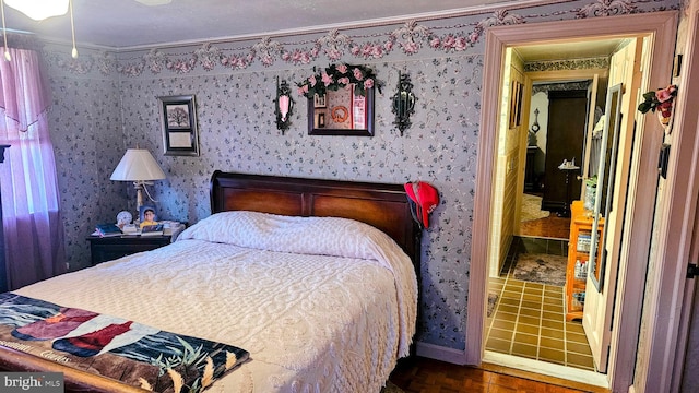 bedroom featuring crown molding and dark wood-type flooring