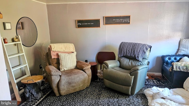 living area featuring crown molding