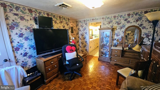 home office featuring dark parquet floors and a textured ceiling