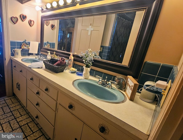 bathroom with vanity and tasteful backsplash