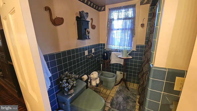 bathroom with toilet and tile walls