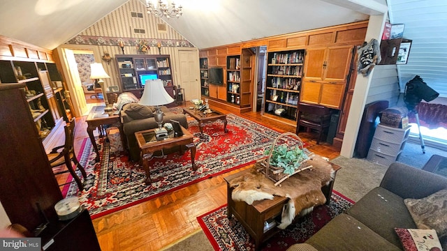 living room with parquet floors, vaulted ceiling, and an inviting chandelier