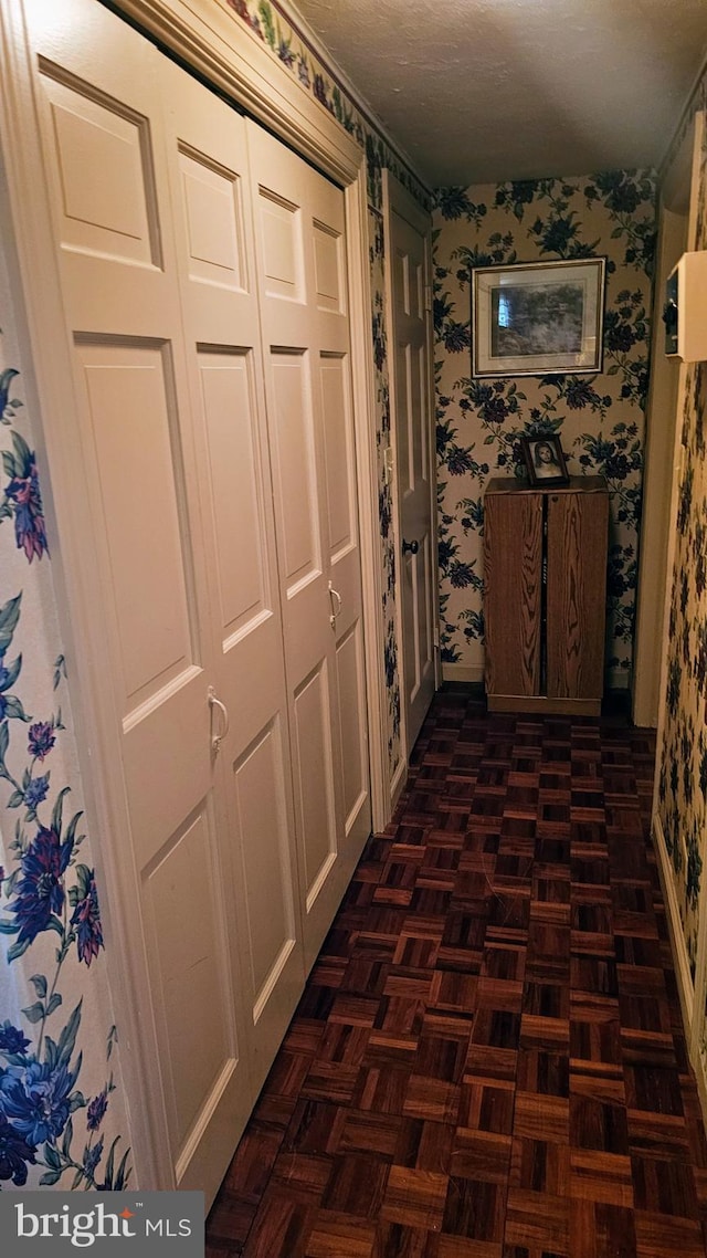 hallway featuring dark parquet flooring