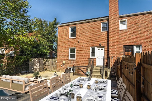 back of property with an outdoor hangout area and a patio area