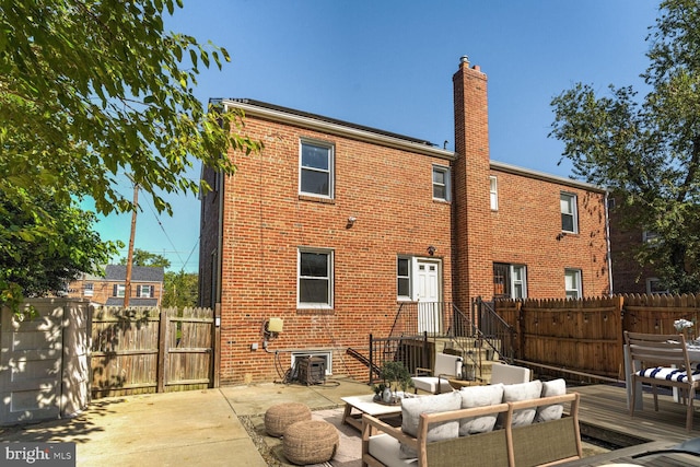 back of house with an outdoor hangout area and a patio