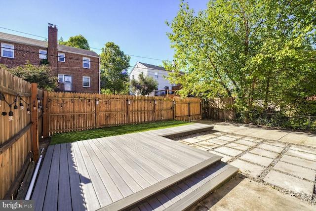 wooden deck with a patio