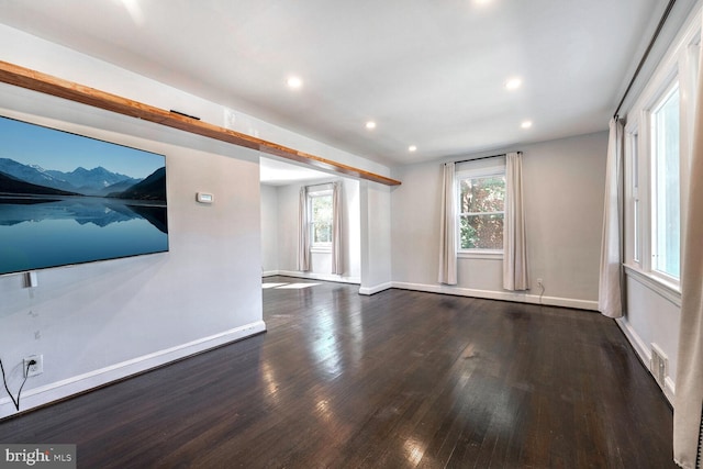 unfurnished living room featuring dark wood-type flooring