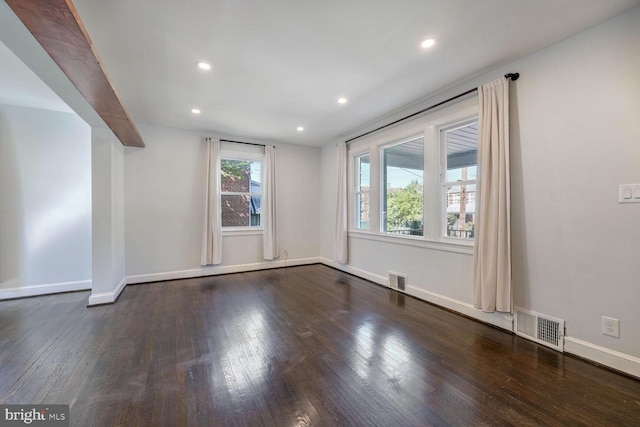 spare room featuring dark hardwood / wood-style flooring