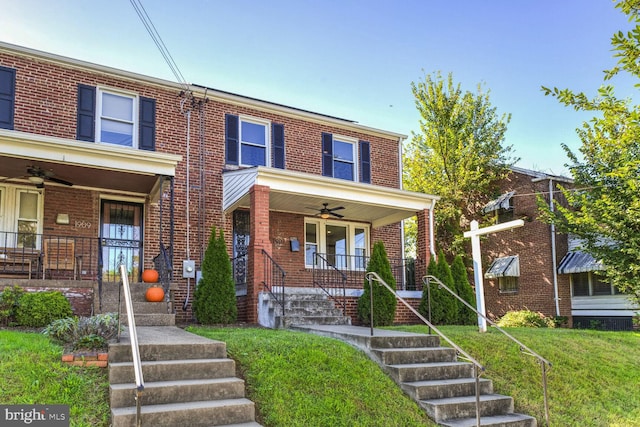 townhome / multi-family property with ceiling fan, a front yard, and a porch