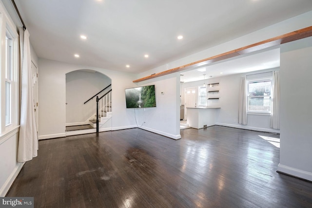 unfurnished living room with dark hardwood / wood-style flooring