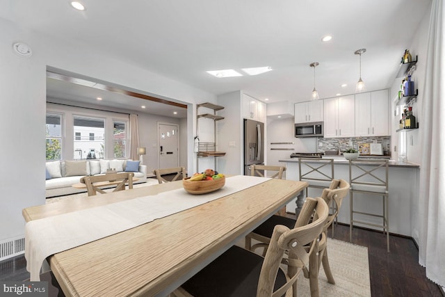 dining area with dark hardwood / wood-style flooring