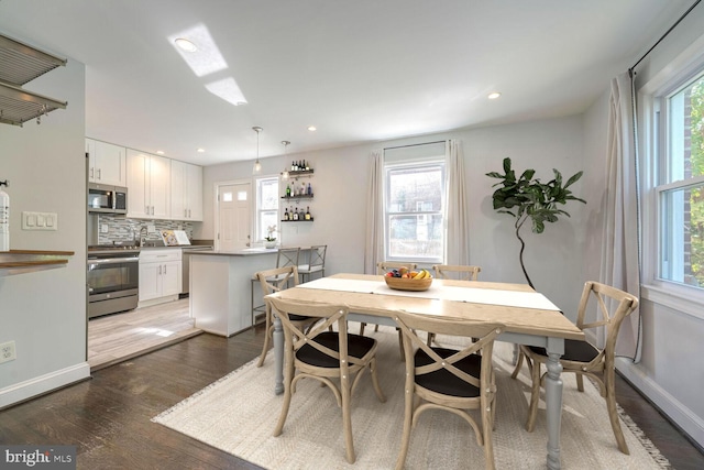 dining space featuring dark wood-type flooring