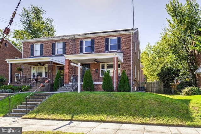 view of front of house featuring covered porch, a front lawn, and ceiling fan