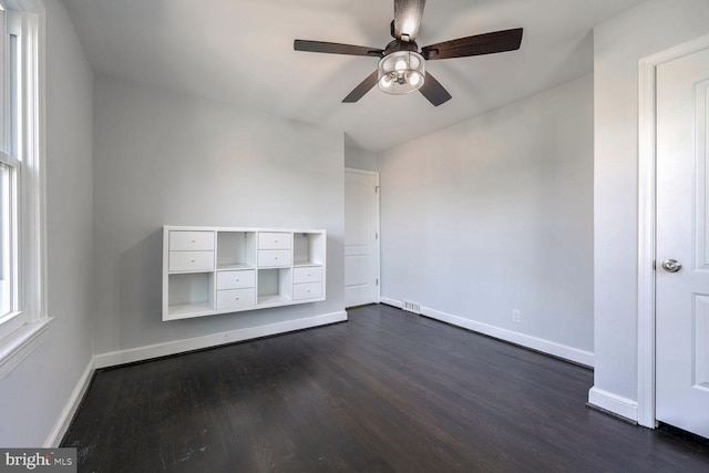 spare room with ceiling fan and dark hardwood / wood-style floors