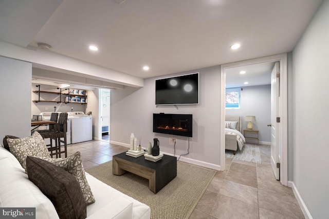 living room featuring washer / dryer and a fireplace