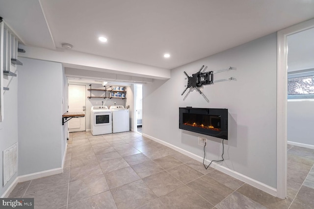 interior space with tile patterned flooring and washer and clothes dryer