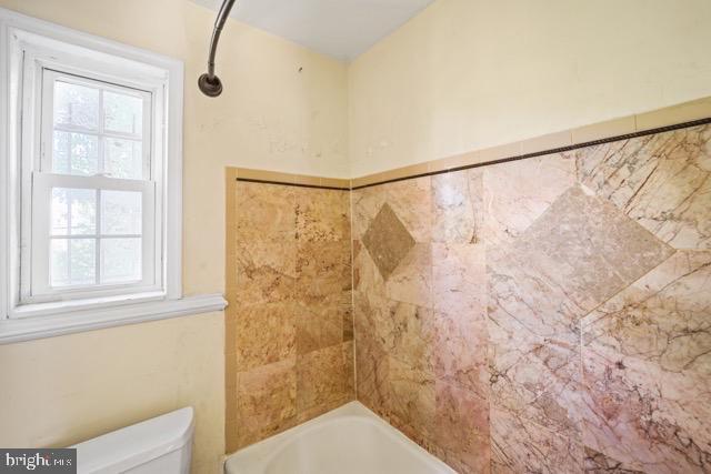 bathroom with healthy amount of natural light and toilet