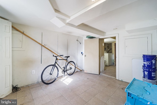 basement with light tile patterned flooring and washer / clothes dryer