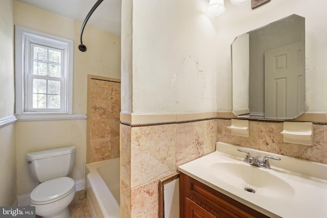bathroom with toilet, vanity, a tub, and a shower