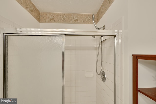 bathroom featuring walk in shower and a textured ceiling