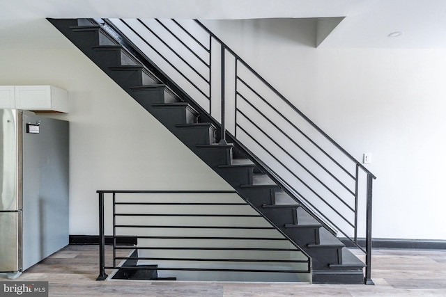 stairs with hardwood / wood-style floors