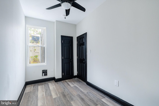 spare room featuring light hardwood / wood-style floors and ceiling fan