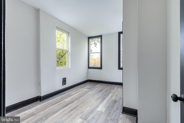 empty room with light hardwood / wood-style flooring