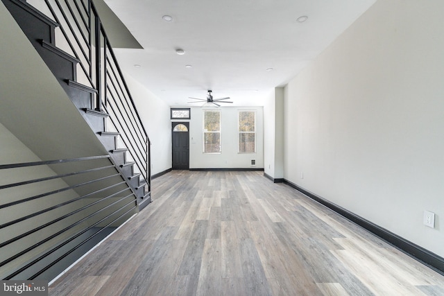 interior space with ceiling fan and wood-type flooring