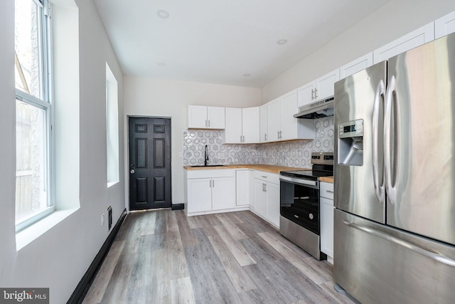 kitchen with white cabinets, light wood-type flooring, sink, and appliances with stainless steel finishes