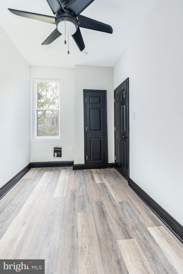 empty room featuring ceiling fan and light hardwood / wood-style flooring