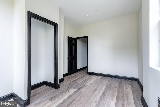 unfurnished room with light wood-type flooring