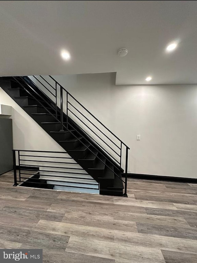 stairway featuring hardwood / wood-style floors