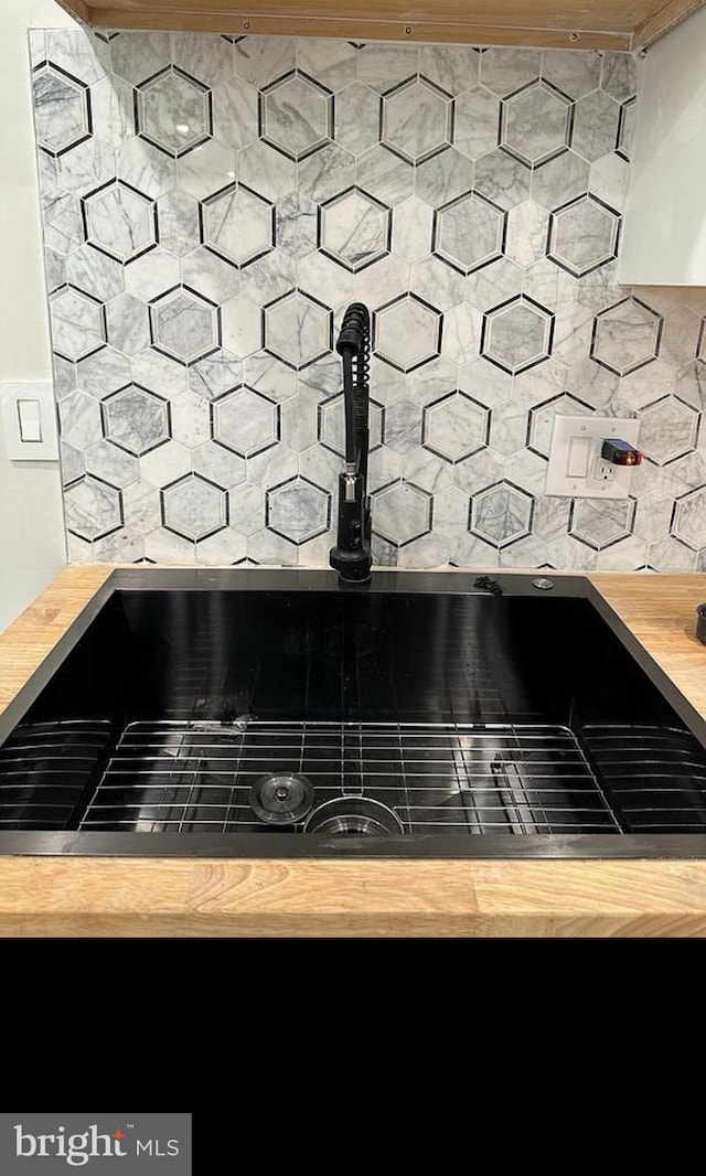 room details with butcher block countertops and decorative backsplash