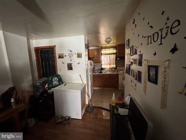 laundry room with wood-type flooring