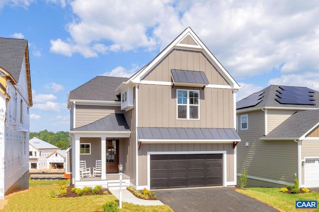 view of front of property with a garage and covered porch