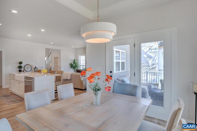 dining room with light hardwood / wood-style floors and sink