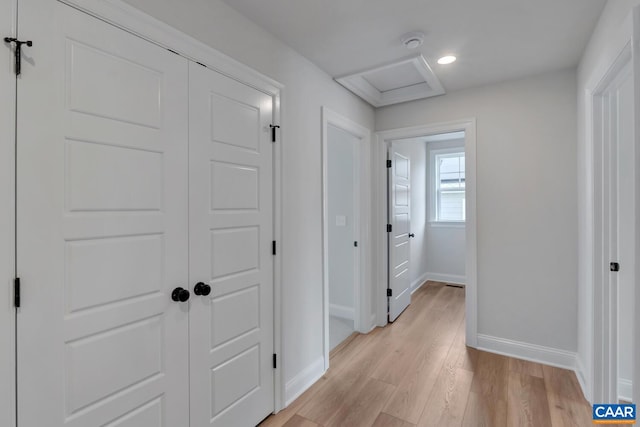 hallway with light hardwood / wood-style flooring