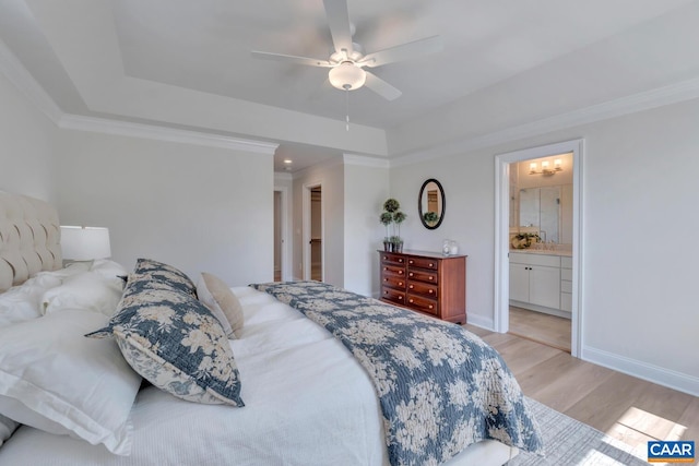 bedroom featuring light hardwood / wood-style flooring, ornamental molding, connected bathroom, and ceiling fan