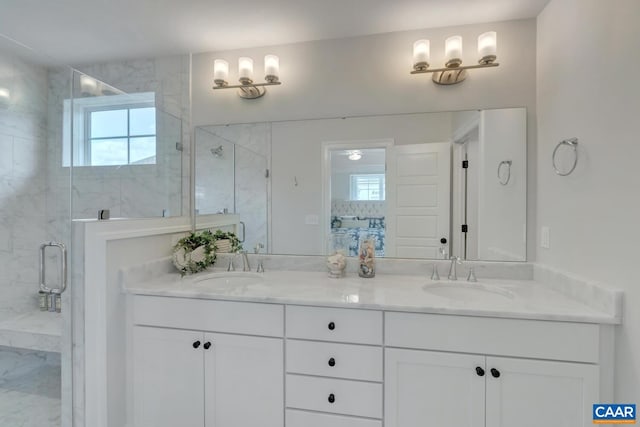 bathroom featuring a shower with door and vanity