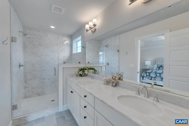 bathroom with vanity and a shower with door