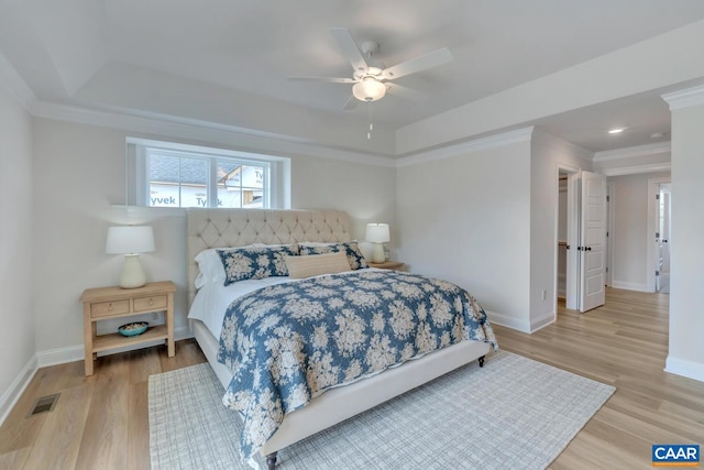 bedroom with light wood-type flooring, crown molding, and ceiling fan