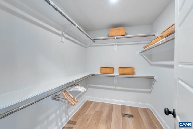 walk in closet featuring light hardwood / wood-style flooring