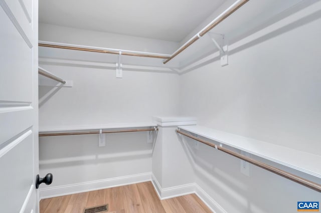 spacious closet featuring light hardwood / wood-style floors