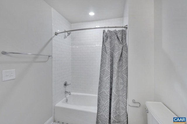 bathroom with shower / bath combo with shower curtain and toilet